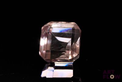 a glass object that is sitting on a black surface