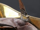 a close up of a leather purse with a metal handle