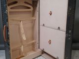 an open suitcase with a tie in it sitting on the floor