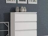 two vases on top of a white dresser in a room