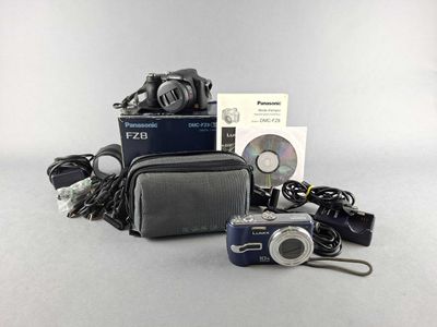 an image of a camera and other electronics on a table