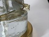 a glass vase sitting on top of a table next to a glass vase