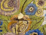 a close up of a tile with flowers on it