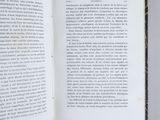 an open book with a picture of a cat sitting on top of it