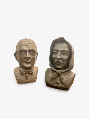 pair of carved stone busts of a man and a woman