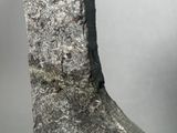 a close up of a piece of metal with a piece of wood sticking out of it