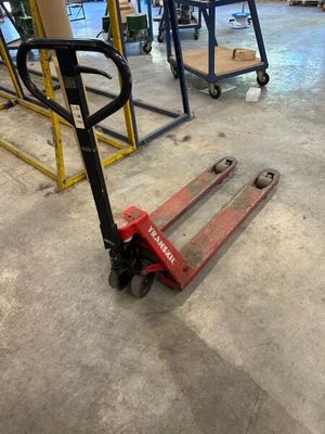 a fork lifter sitting on the floor in a warehouse