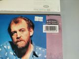 a picture of a man with a beard and a blue shirt