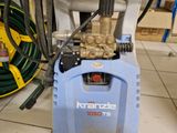 a blue machine that is sitting on a tiled floor