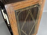 an image of a wooden cabinet with a black and gold design