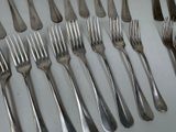 a lot of forks and spoons that are on the table