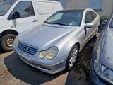 a silver car parked next to other cars in a parking lot