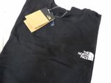 the north face logo on a black shirt with a tag