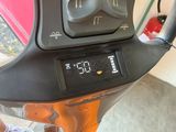 a close up of a digital clock on a motorcycle
