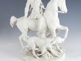 statue of a man on a horse with a dog and a dog