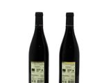 two bottles of wine sitting next to each other on a white surface