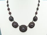 the necklace is made of glass beads and beads with black beads