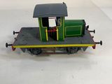 a toy train with a caboose sitting on a white surface