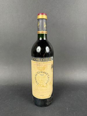 a bottle of red wine sitting on top of a table