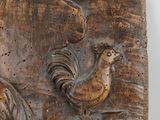 a wooden plaque with a rooster and a bird on it