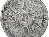 un gros plan d'une pièce de monnaie sur laquelle figure un soleil