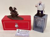 two figurines of a man and a woman on a red box