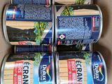 four cans of beer are stacked in a cardboard box