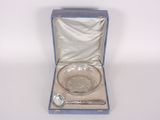 a glass bowl and spoon in a blue box