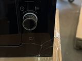 microwave sitting on top of a table in a warehouse