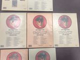 six lp ' s of the rolling stones, including a picture of a man in a hat and a man
