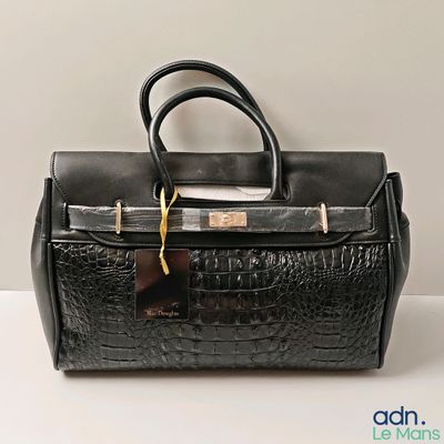 an image of a black purse sitting on top of a white table