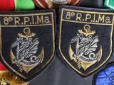 several military patches are displayed on top of each other on a table