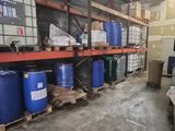 a room with a lot of barrels and boxes on the shelves