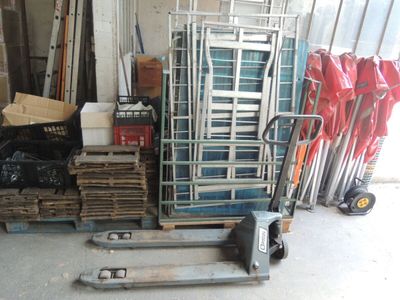 a stack of chairs and a pallet in a garage