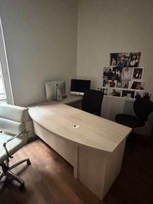 a desk and chair in the corner of a room