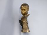 a statue of a boy holding a bird on a stand