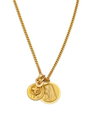 a close up of a gold necklace with a coin on it