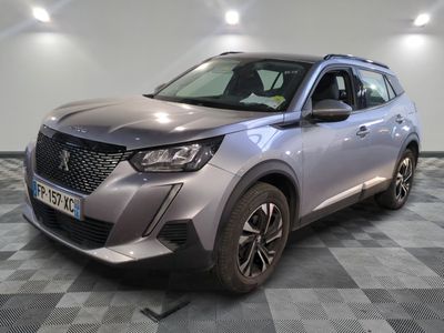 the front of a silver suv parked on a checkered floor