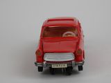 a red toy car that is sitting on a white surface