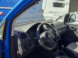 a blue van that is parked next to a white van