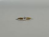 a close up of a diamond ring on a white surface