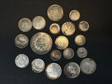 a lot of coins that are on a black surface