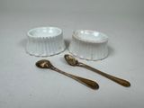 two bowls and spoons sitting next to each other on a table