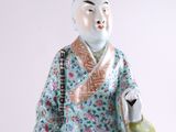 a figurine of a man holding a tea pot
