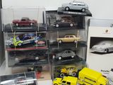 a lot of toy cars on display in a display case