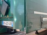 a large green truck parked on the side of the road