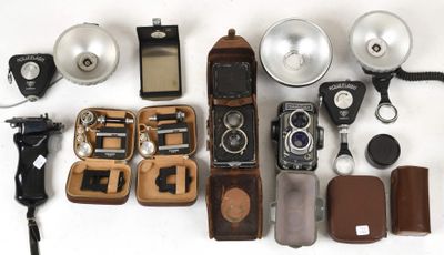 many different types of photography equipment laid out on a white surface