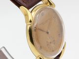 a close up of a wrist watch with a brown leather strap