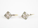 une image d'une paire de boucles d'oreilles en diamant sur fond blanc