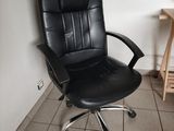 a black office chair sitting in a corner of a room